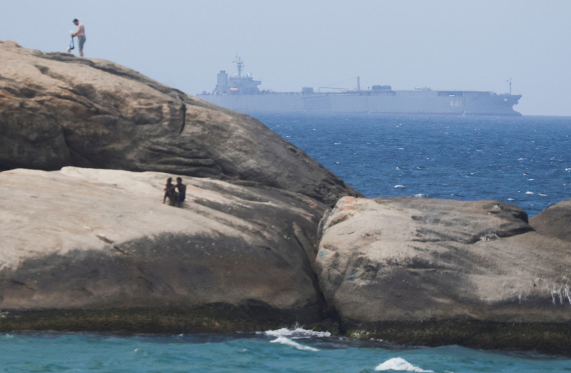  Iranian military ship Iris Makran navigates on the coast of Rio de Janeiro as beachgoers sunbathe on the stones of Arpoador Beach, Brazil, February 27, 2023. (credit: REUTERS/RICARDO MORAES)