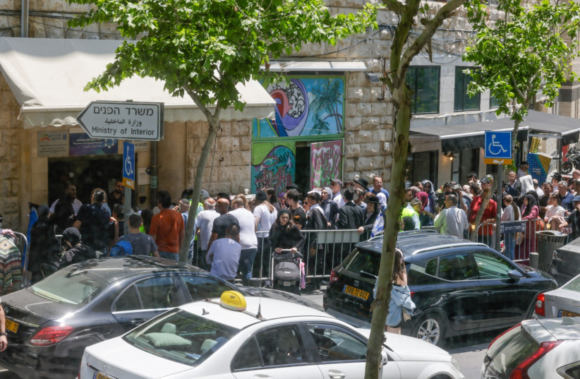 People queue outside Jerusalem Interior Ministry office for passport renewals. May 2023. (photo credit: MARC ISRAEL SELLEM)