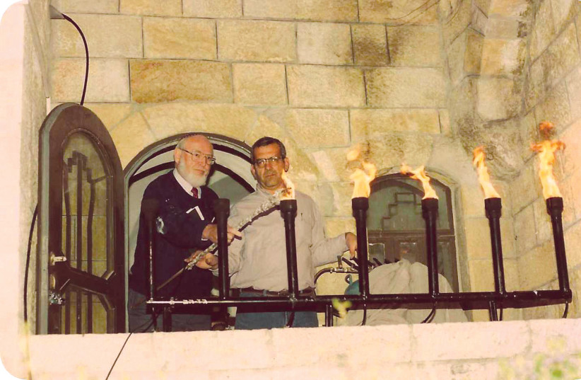  LIGHTING A torch for a Remembrance Day-Independence Day ceremony at Menachem Tzion Synagogue in the Jewish Quarter, with Yossi Eliav (R), 1989.  (credit: Courtesy Abramowitz family)