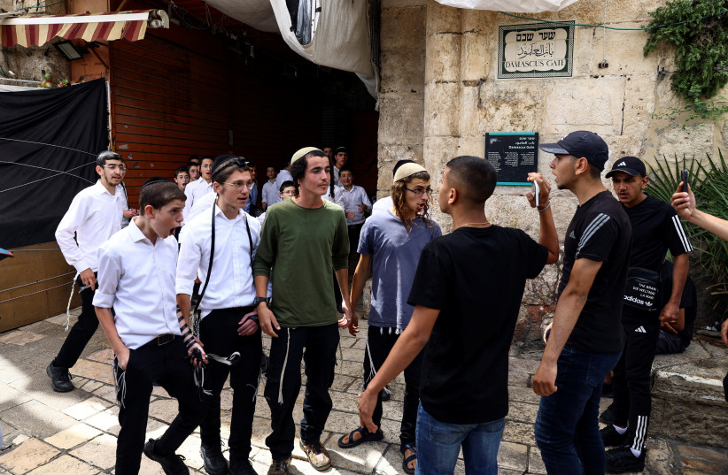  Israelis and Palestinains argue near Damascus gate to Jerusalem's Old city as Israel mark Jerusalem Day in Jerusalem May 18, 2023 (photo credit: RONEN ZVULUN/REUTERS)
