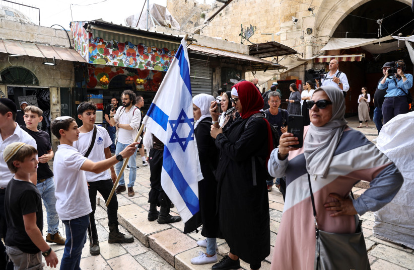  Israelis and Palestinians stand opposite to each other near Damascus gate to Jerusalem's Old city as Israel mark Jerusalem Day, in Jerusalem May 18, 2023. (credit: RONEN ZVULUN/REUTERS)