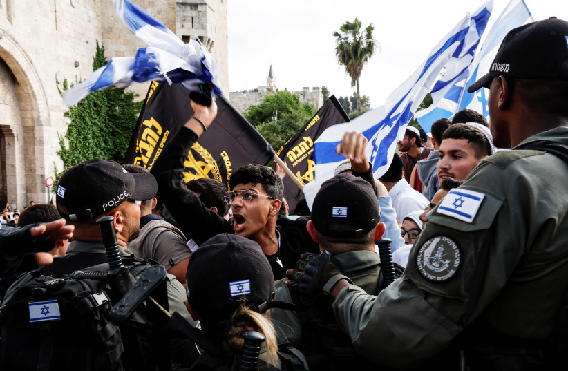  Israeli security personnel stand by as Israelis shout slogans and gather at Damascus gate to Jerusalem's Old city marking Jerusalem Day, in Jerusalem May 18, 2023 (photo credit: AMMAR AWAD/REUTERS)