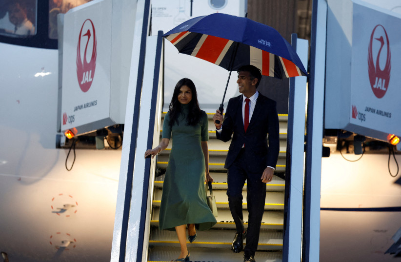 British Prime Minister Rishi Sunak accompanied by his wife Akshata Murty, arrives at Hiroshima airport, ahead of the G7 leaders' summit in Mihara, Hiroshima, Japan May 18, 2023.  (photo credit: REUTERS/Androniki Christodoulou)