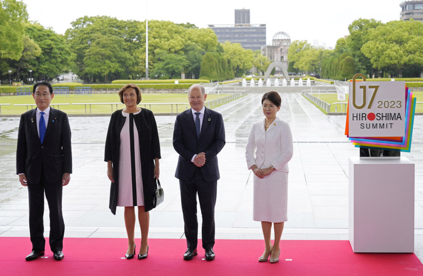 German Chancellor Olaf Scholz and his wife Britta Ernst pose for a photo with Japan’s Prime Minister Fumio Kishida and his wife Yuko Kishida at the Peace Memorial Park during a visit as part of the G7 Hiroshima Summit in Hiroshima, Japan, 19 May 2023. The G7 Hiroshima Summit will be held from 19 to  (photo credit: FRANCK ROBICHON POOL/Pool via REUTERS)