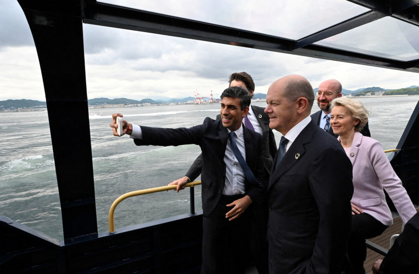 Britain's Prime Minister Rishi Sunak takes a selfie with Canada's Prime Minister Justin Trudeau, Germany's Chancellor Olaf Scholz, European Commission President Ursula von der Leyen and President of the European Council Charles Michel as they board a ship toward to the Itsukushima Shrine with other  (credit: Ministry of Foreign Affairs of Japan/HANDOUT via REUTERS)