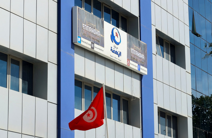 A Tunisian flag flutters outside the building of Ennahda party headquarters, after police raided the headquarters early on Tuesday and evacuated all present to start a search that will take days, after showing a judicial warrant, party officials said, in Tunis, Tunisia April 18, 2023.  (credit: REUTERS/JIHED ABIDELLAOUI)