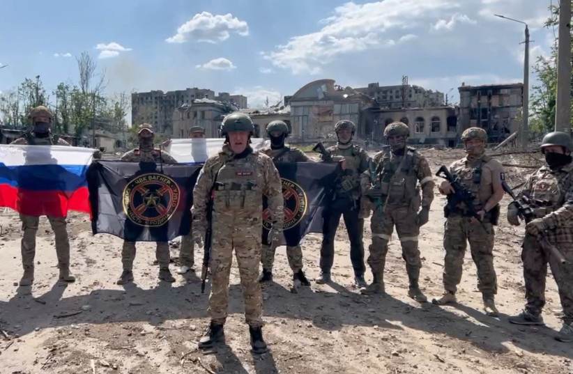  Founder of Wagner private mercenary group Yevgeny Prigozhin makes a statement as he stand next to Wagner fighters in the course of Russia-Ukraine conflict in Bakhmut, Ukraine, in this still image taken from video released May 20, 2023.  (photo credit: PRESS SERVICE OF "CONCORD"/HANDOUT VIA REUTERS)
