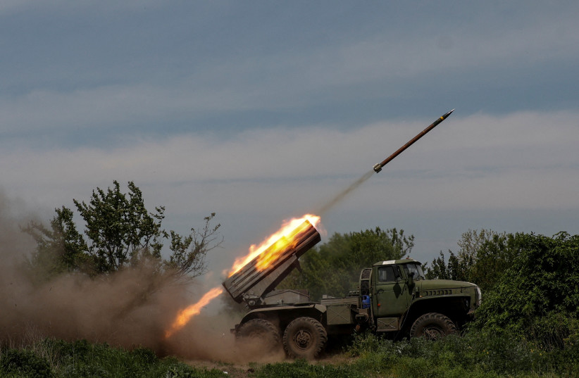  Ukrainian servicemen fire a BM-21 Grad multiple launch rocket system towards Russian troops, amid Russia's attack on Ukraine, near the frontline town of Bakhmut, Ukraine May 19, 2023 (photo credit: RADIO FREE EUROPE/RADIO LIBERTY/SERHII NUZHNENKO VIA REUTERS)
