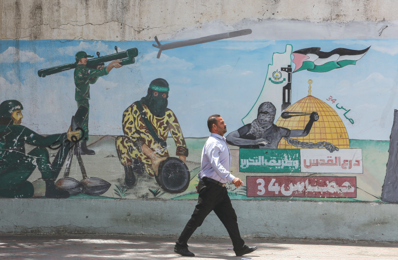  A MURAL in Khan Yunis, Gaza Strip, depicts Hamas fighters firing rockets. (photo credit: ABED RAHIM KHATIB/FLASH90)