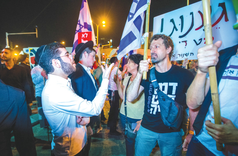  PROTESTERS AGAINST funding for ultra-Orthodox political parties argue with haredi counter-demonstrators in Bnei Brak, last Wednesday. (photo credit: FLASH90)
