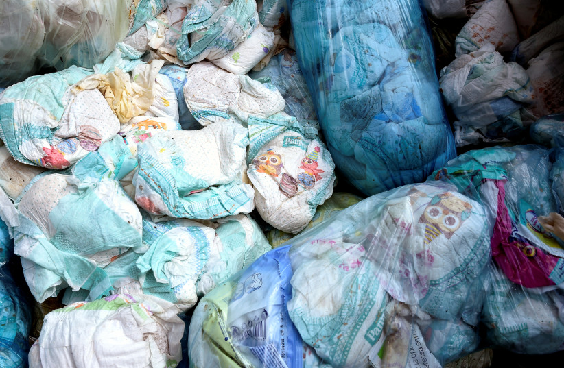  Used diapers are seen in a diaper recycling facility in Spresiano near Treviso, northern Italy, August 31, 2018. (photo credit: MASSIMO PINCA/REUTERS)