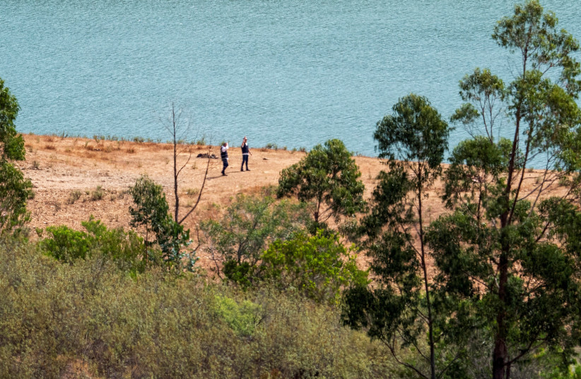  Officers of Portugal's investigative Judicial Police are seen at the site of a remote reservoir where a new search for the body of Madeleine McCann is set to take place, in Silves, Portugal, in this screen grab from a video, May 22, 2023 (photo credit: REUTERS)
