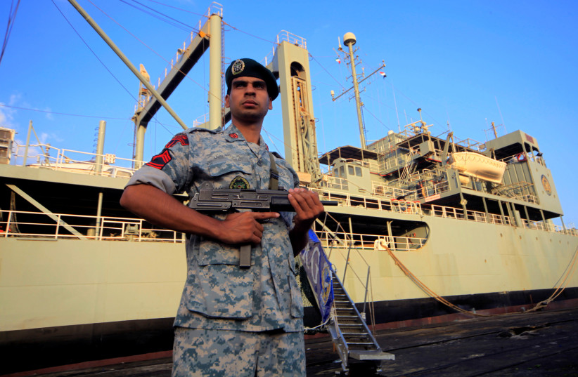  An Iranian soldier stands guard near Iranian Navy helicopter carrier Kharg at Port Sudan at the Red Sea State, October 31, 2012. (photo credit: MOHAMED NURELDIN ABDALLAH/REUTERS)