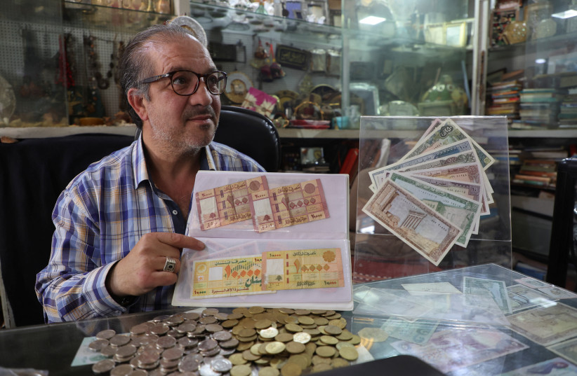  Lebanese collector of banknotes and coins, Ahmad Raghdo displays Lebanese banknotes inside his shop in Beirut, Lebanon May 8, 2023. (credit: REUTERS/MOHAMED AZAKIR)