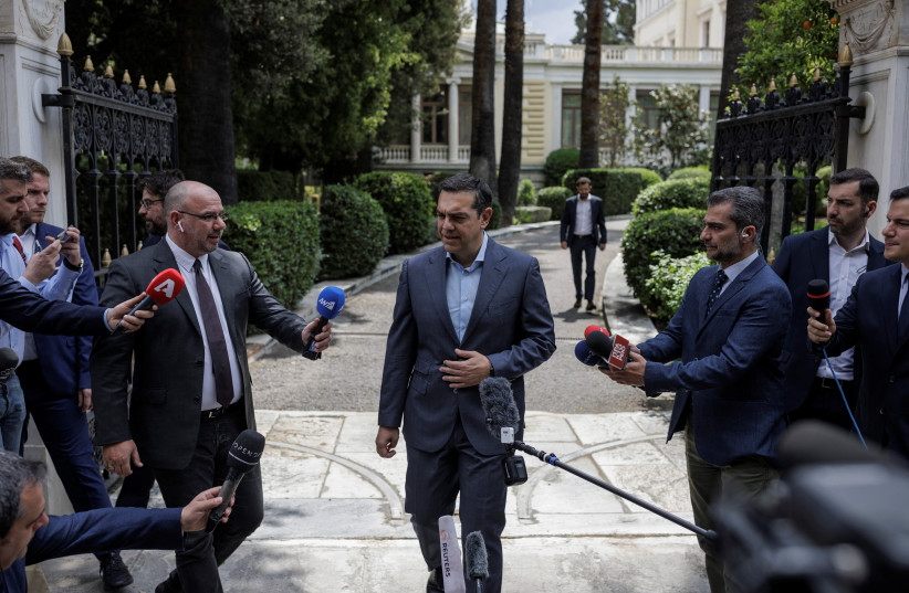  Leftist Syriza party leader Alexis Tsipras speaks to journalists outside the Presidential Palace, after a meeting with Greek President Katerina Sakellaropoulou, where he received an official mandate to try to form a coalition government after the general election in Athens, Greece, May 23, 2023. (photo credit: Alkis Konstantinidis/Reuters)