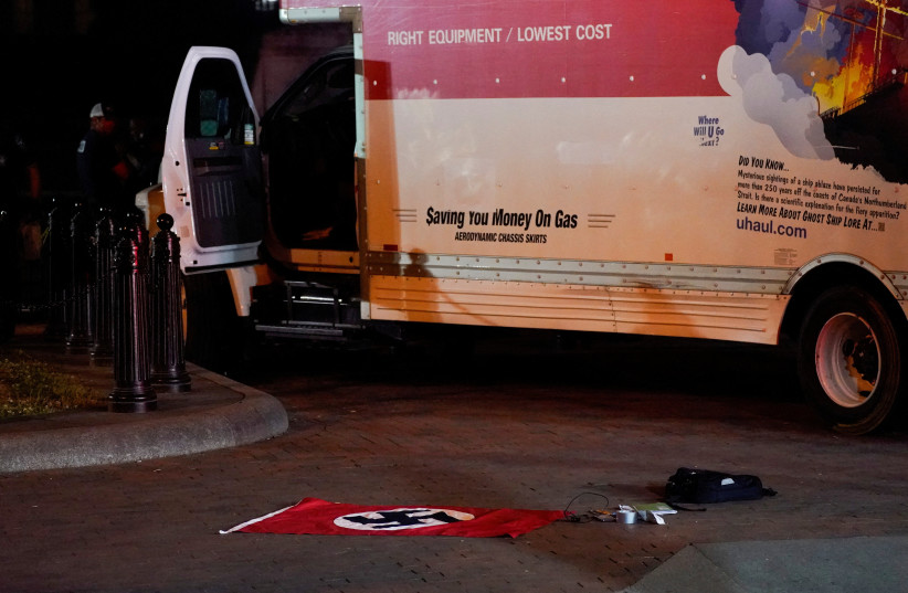  A Nazi flag and other objects recovered from a rented box truck are pictured on the ground as the U.S. Secret Service and other law enforcement agencies investigate the truck that crashed into security barriers at Lafayette Park across from the White House in Washington, U.S. May 23, 2023. (photo credit: REUTERS)
