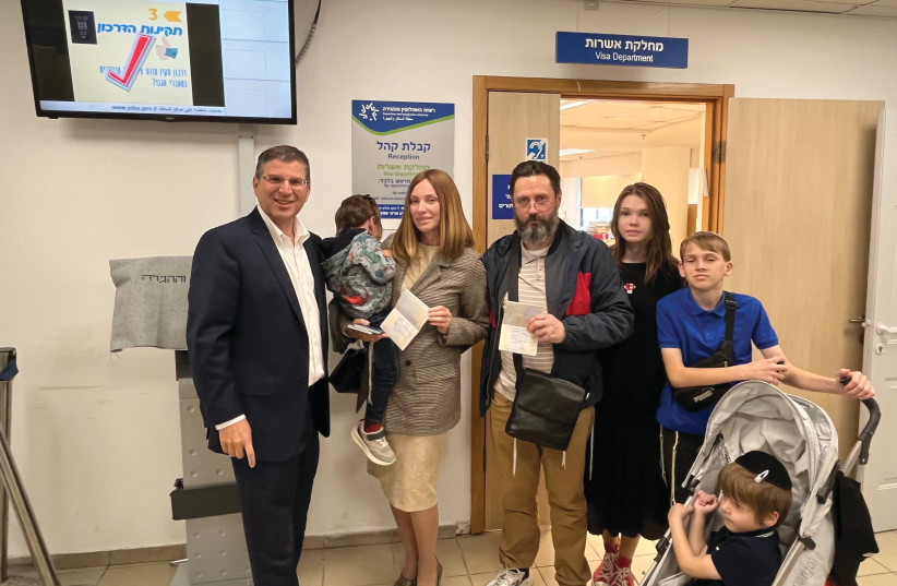  THE AGPOV family with ITIM head Rabbi Seth Farber (L) after receiving Israeli citizenship at the Netanya Interior Ministry offices. (photo credit: COURTESY ITIM)