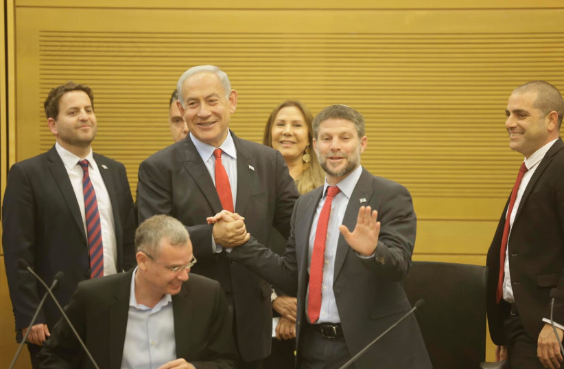  Prime Minister Benjamin Netanyahu and Finance Minister Bezalel Smotrich greet eachother before Netanyahu's budget speech on May 23, 2023.  (credit: MARC ISRAEL SELLEM/THE JERUSALEM POST)