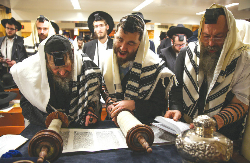 READING FROM the Torah in synagogue: Shavuot celebrates the giving of the Ten Commandments. These commandments, like the Torah, offer stories, insights, values and actions as ways in to God (credit: NATI SHOHAT/FLASH90)