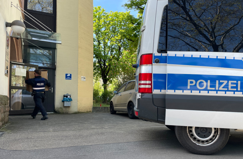 Police officers carry boxes into a police building in Mainz, Germany, May 3, 2023, after German police arrested dozens of people across the country on Wednesday in an investigation of the Italian 'Ndrangheta organised crime group, German public prosecutors and state police said. (photo credit: REUTERS/Timm Reichert)