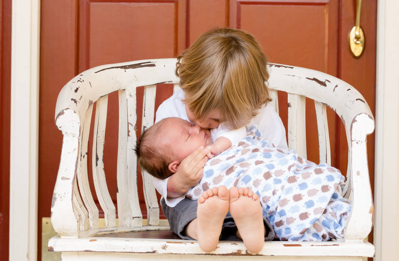  How can you help your oldest child adjust to a new sibling? (illustrative) (credit: PEXELS)