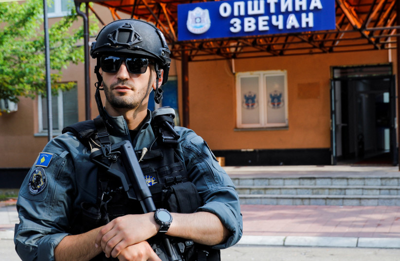 A member of Kosovo special police forces guards the municipal offices in Zvecan after ethnic Serb protestors tried to prevent a newly-elected ethnic Albanian mayor from entering the office in Zvecan, Kosovo, May 27, 2023 (credit: OGNEN TEOFILOVSKI/REUTERS)