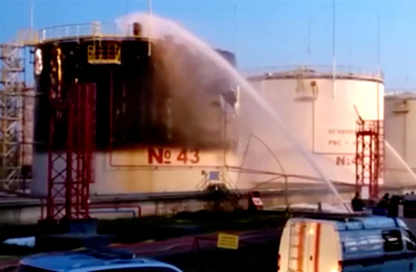  Firefighters work to put out a fire at product storage facilities of the Ilsky oil refinery in the settlement of Ilsky in the Krasnodar region, Russia, in this still image taken from video released May 4, 2023.  (credit: Governor of Krasnodar Region Veniamin Kondratyev via Telegram/Handout/Handout via REUTERS)