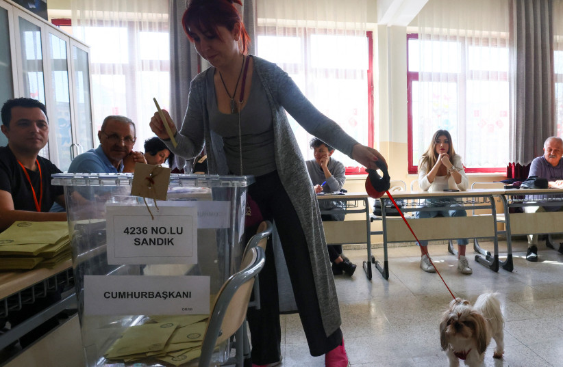  A person casts her vote at a polling station during the second round of the presidential election in Ankara, Turkey May 28, 2023.  (credit: YVES HERMAN/REUTERS)