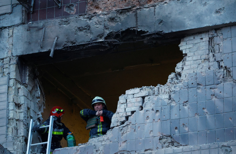  Rescuers work at a site of a building damaged during a Russian suicide drone strike, amid Russia's attack on Ukraine, in Kyiv, Ukraine May 28, 2023.  (credit: VALENTYN OGIRENKO/REUTERS)