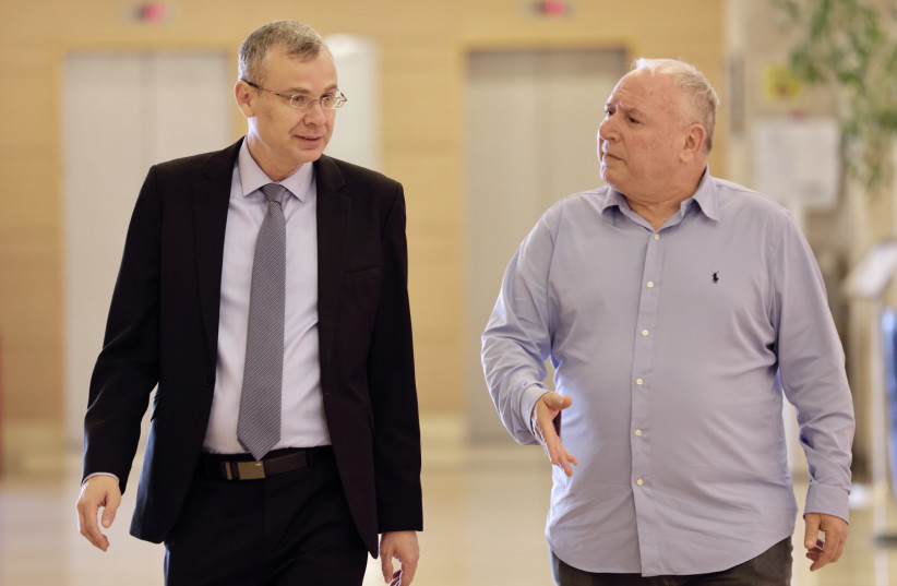 Justice Minister Yariv Levin and David Amsalem, a minister in the Justice Ministry, are seen walking down a hallway in the Knesset on May 29, 2023 (credit: MARC ISRAEL SELLEM)