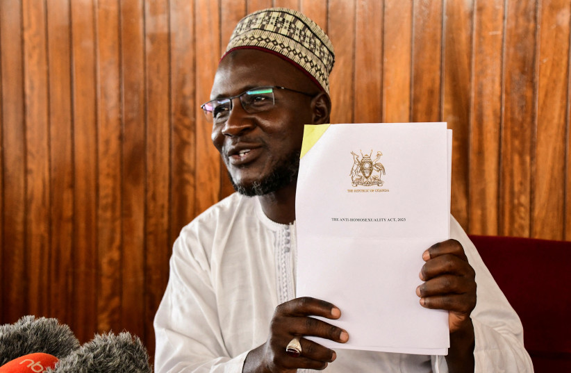  Bugiri Municipality Member of Parliament Asuman Basalirwa, and the mover of the anti-homosexuality bill, displays the signed law as he addresses a press conference in Kampala, Uganda May 29, 2023 (credit:  REUTERS/ABUBAKER LUBOWA)