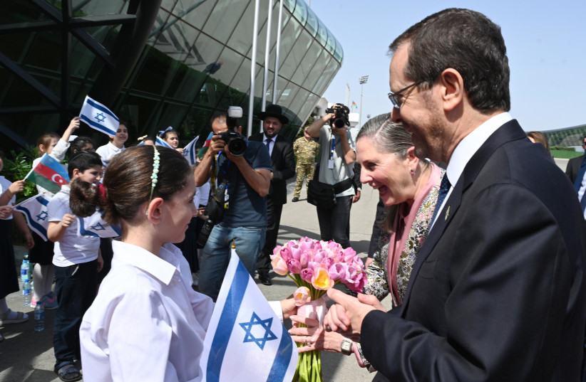 President Isaac Herzog and first lady Michal Herzog are greeted upon their arrival in Baku for a state visit in Azerbaijan on May 30, 2023 (credit: HAIM ZACH/GPO)
