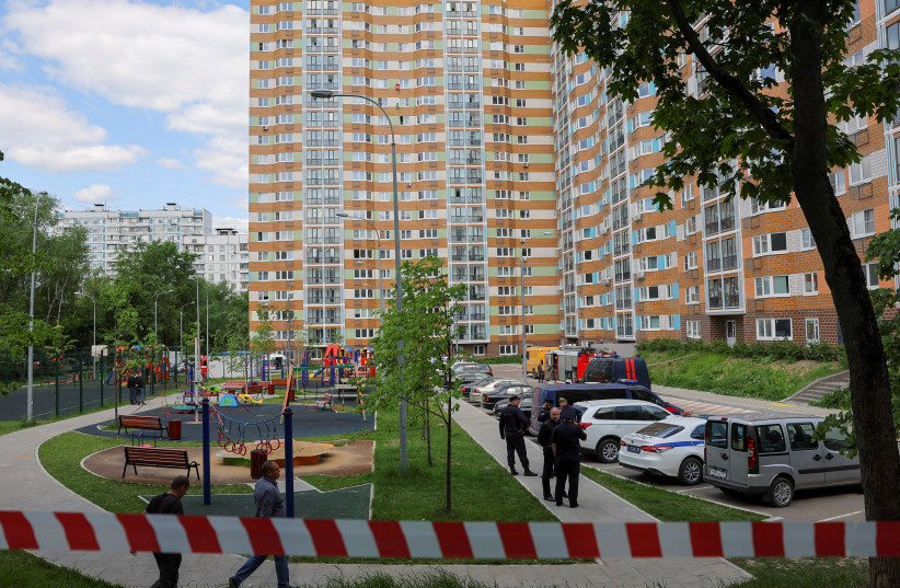  Police tape blocks off an accident scene near a damaged multi-storey apartment block following a reported drone attack in Moscow, Russia, May 30, 2023. (credit: REUTERS)