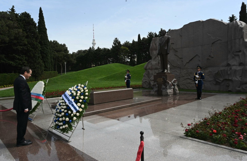  Israeli President Isaac Herzog is seen laying a wreathe in Azerbaijan, on May 30, 2023. (credit: HAIM ZACH/GPO)