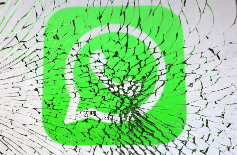  Whatsapp logo is seen through broken glass in this illustration taken, January 25, 2023. (credit: REUTERS/DADO RUVIC/ILLUSTRATION)