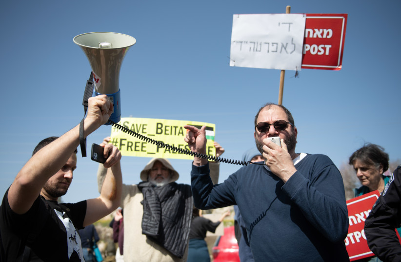  MK Ofer Cassif speaks during a protest of Palestinians and left-wing activists against the Evyatar outpost, near the West Bank city of Nablus, on February 18, 2022. (credit: SRAYA DIAMANT/FLASH90)