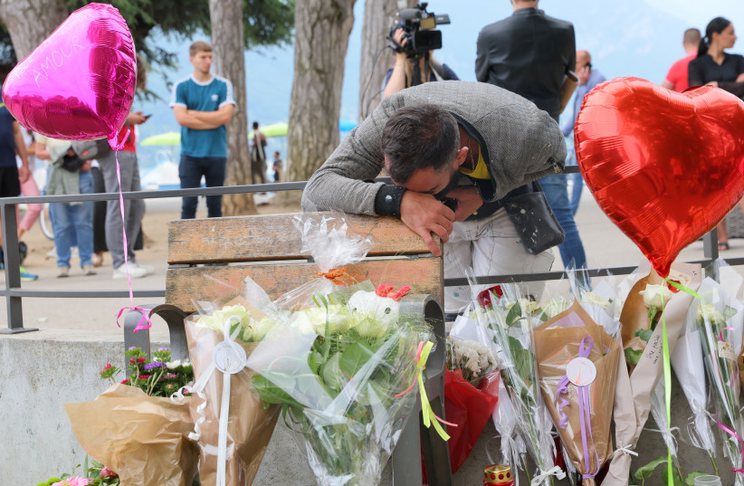  Salih Ismajl cries in front of messages and floral tributes at the children's playground the day after several children and adults were injured in a knife attack at the Le Paquier park near the lake in Annecy, in the French Alps, France, June 9, 2023 (credit: REUTERS/DENIS BALIBOUSE)