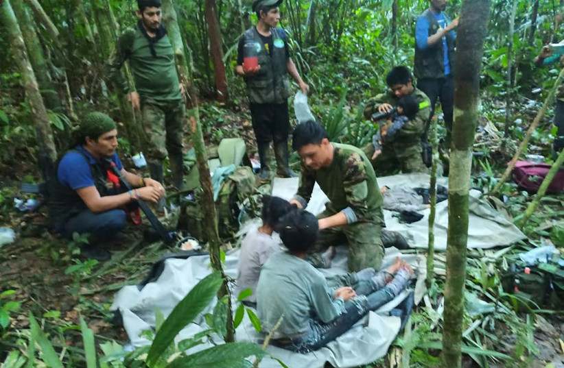 Colombian military soldiers attend to child survivors from a Cessna 206 plane that crashed in the jungles of Caqueta, in limits between Caqueta and Guaviare, June 9, 2023. (credit: Colombian Military Forces/Handout via REUTERS)