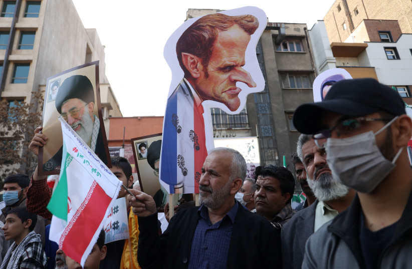  A demonstrator holds an image with a caricature of France President Emmanuel Macron during the 43rd anniversary of the US expulsion from Iran, in Tehran, Iran November 4, 2022 (credit: MAJID ASGARIPOUR/WANA (WEST ASIA NEWS AGENCY) VIA REUTERS)