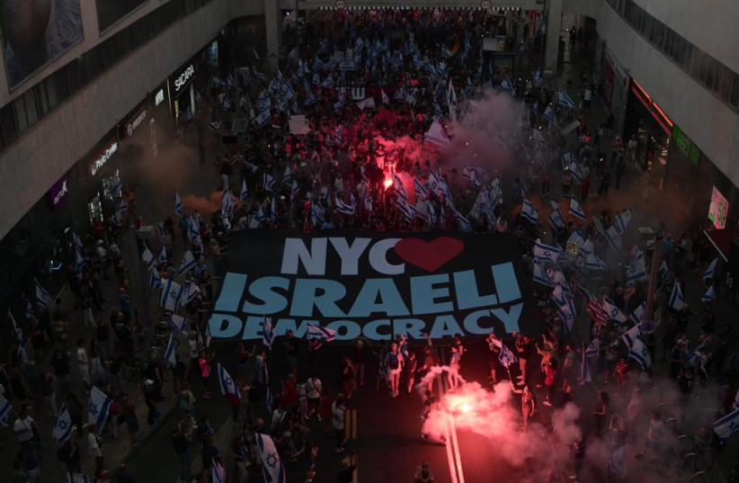  Protesters of the judicial reform bring a sign saying ''NYC loves Israeli democracy'' during the 23rd week of protests June 10, 2023. (credit: AVSHALOM SASSONI/MAARIV)