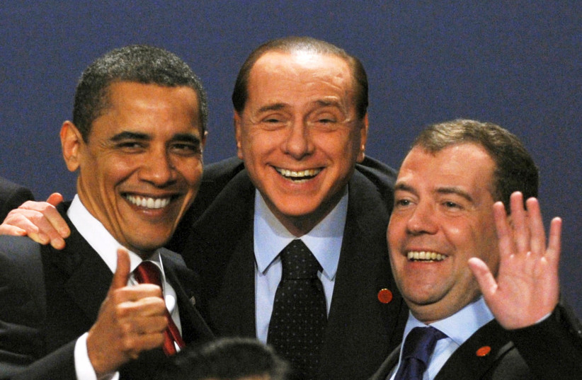 US President Barack Obama laughs with Italy's Prime Minister Silvio Berlusconi and Russia's President Dmitry Medvedev as they pose for a family photograph at the G20 summit at the ExCel centre, in east London, Britain, April 2, 2009. (credit: STRINGER/ REUTERS)