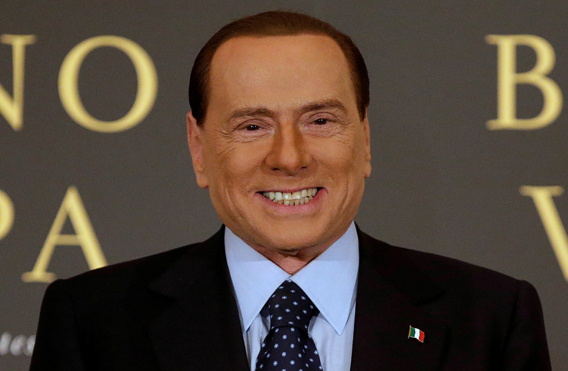  Former Italian Prime Minister Silvio Berlusconi smiles as he arrives to attend the book launch of his friend, TV presenter Bruno Vespa, in Rome, Italy, December 12, 2012.  (credit: TONY GENTILE/REUTERS)