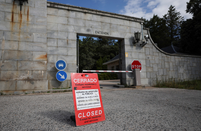 A sign informing visitors that the 'Valley of the Fallen' monument, now known as Valley of Cuelgamuros, is closed to the general public as forensic scientists begin work to remove the remains of 128 victims of the Spanish Civil War who are buried at the site, near Madrid, Spain, June 12, 2023.  (credit: REUTERS/VIOLETA SANTOS MOURA)