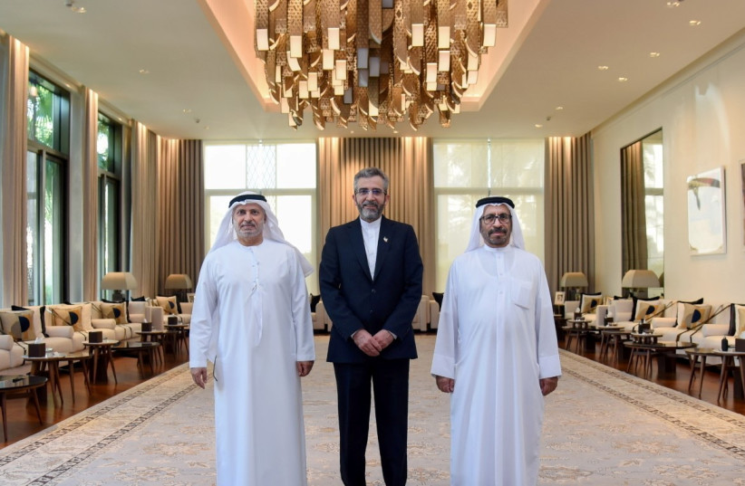  Iran's top nuclear negotiator Ali Bagheri Kani poses for a photo with diplomatic adviser to the UAE's President, Anwar Gargash, and Emirati Minister of State for Foreign Affairs Khalifa Shaheen Almarar during a visit to the country, in Dubai, United Arab Emirates November 24, 2021. (credit: WAM/HANDOUT VIA REUTERS)