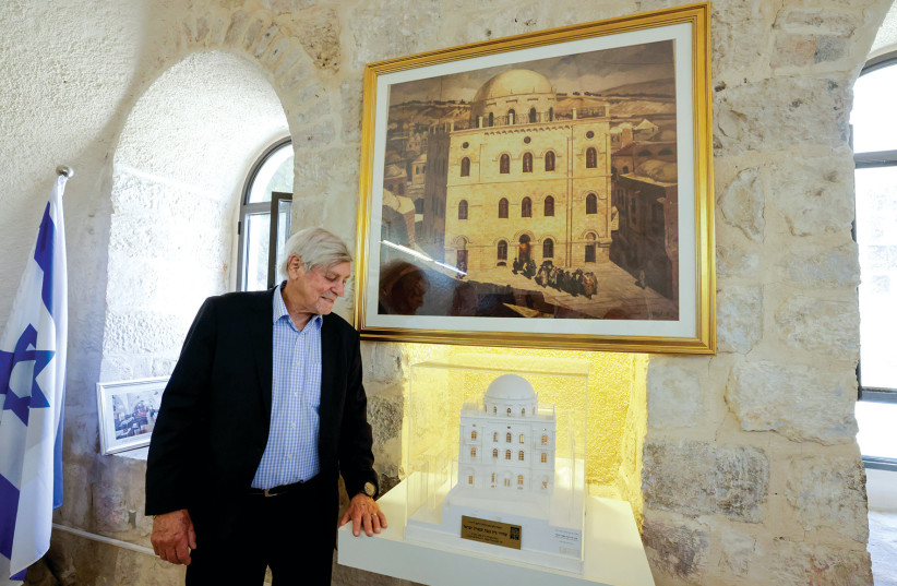  Brian Sherr stands in front of an old photograph and model of the Tiferet Israel Synagogue. (credit: MARC ISRAEL SELLEM)