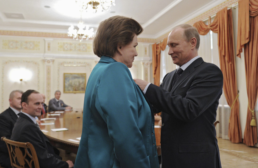 Russia's President Vladimir Putin decorates Valentina Tereshkova, the first woman cosmonaut, with the Order of Alexander Nevsky during a meeting at the Novo-Ogaryovo state residence outside Moscow June 14, 2013. The meeting was dedicated to the 50th anniversary of Tereshkova's historic flight. (credit: REUTERS/Mikhail Klimentyev/RIA Novosti/Kremlin)