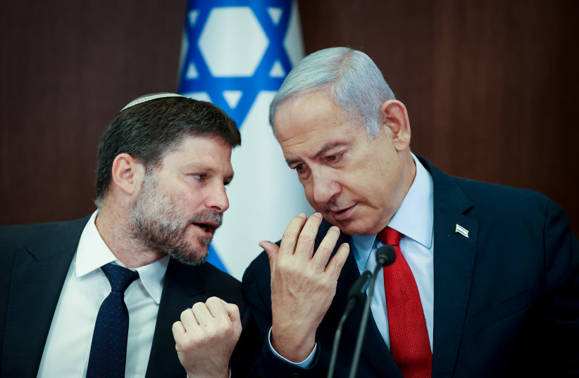  Israeli Prime Minister Benjamin Netanyahu speaks with Israeli Finance Minister Bezalel Smotrich at a cabinet meeting at the Prime Minister's Office in Jerusalem on June 18, 2023. (credit: AMIT SHABI/POOL)