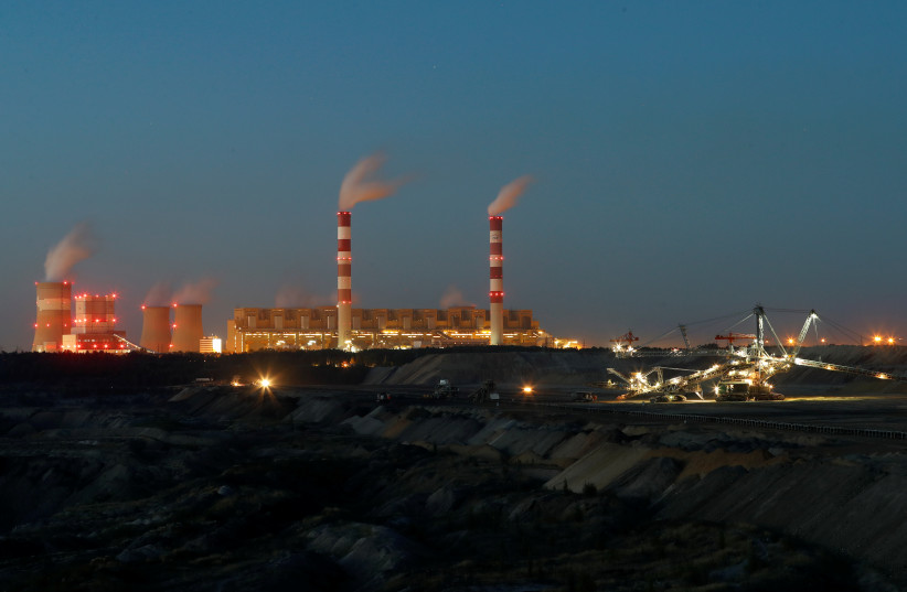  Belchatow Coal Mine, the biggest opencast mine of brown coal in Poland, outside Belchatow Power Station, Europe's largest coal-fired power plant operated by PGE Group, is pictured at night near Belchatow, September 12, 2018.  (credit: REUTERS/KACPER PEMPEL)