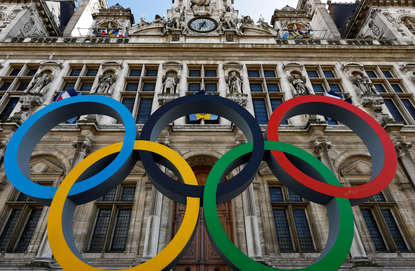  The Olympic rings are seen in front of the Hotel de Ville City Hall in Paris, France, March 14, 2023. (credit: REUTERS/GONZALO FUENTES)