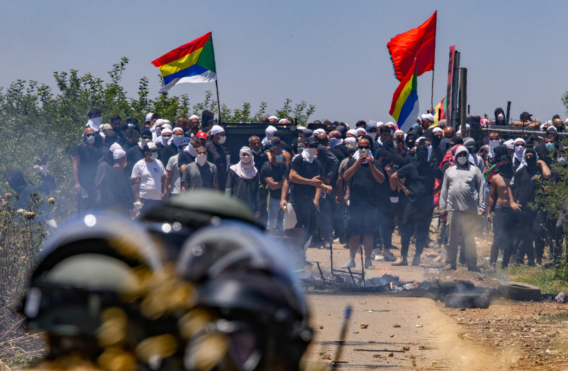  Druze protest while police guard during a protest against the construction of a new wind farm near the Druze village of Majdal Shams, in the Golan Heights, June 21, 2023.  (credit: AYAL MARGOLIN/FLASH90)